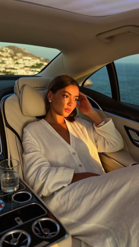 Guest relaxing in the rear lounge seat of a Mercedes-Maybach S-Class